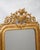 Antique French Gold Gilt Mirror with a Vase and Flower Crest, Circa 1880. This gorgeous antique mirror dates back to...