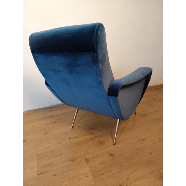 A pair of 1950s "Lady" armchairs by designer Marco Zanuso. The armchairs were reupholstered 10 years ago and are in...