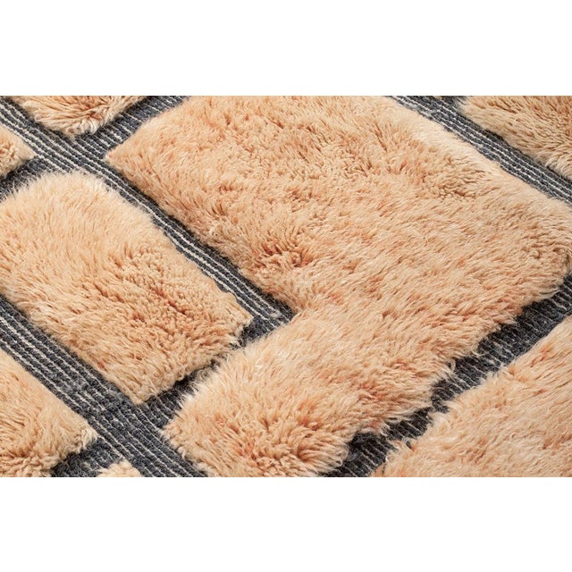 Architectural precision meets warm, earthy texture. This hand-knotted Moroccan rug features a sophisticated fragmented...