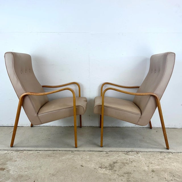 Add a touch of classic mid-century charm to your home with this pair of vintage Thonet-style lounge chairs. Featuring...