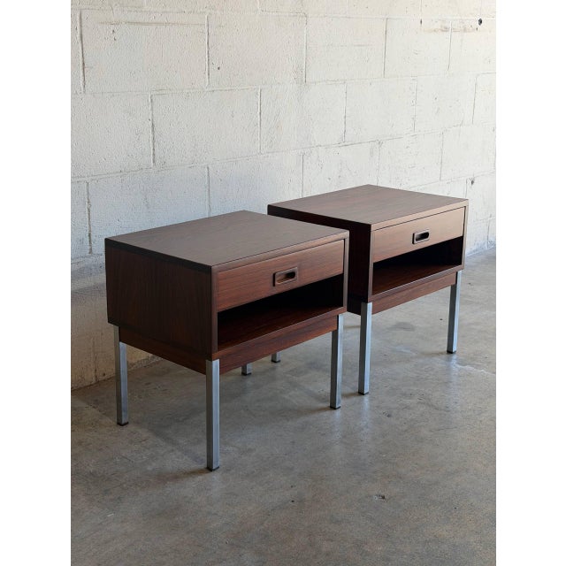 These striking nightstands feature a clean boxy silhouette elevated by sleek square metal legs. The practical design...