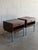 These striking nightstands feature a clean boxy silhouette elevated by sleek square metal legs. The practical design...