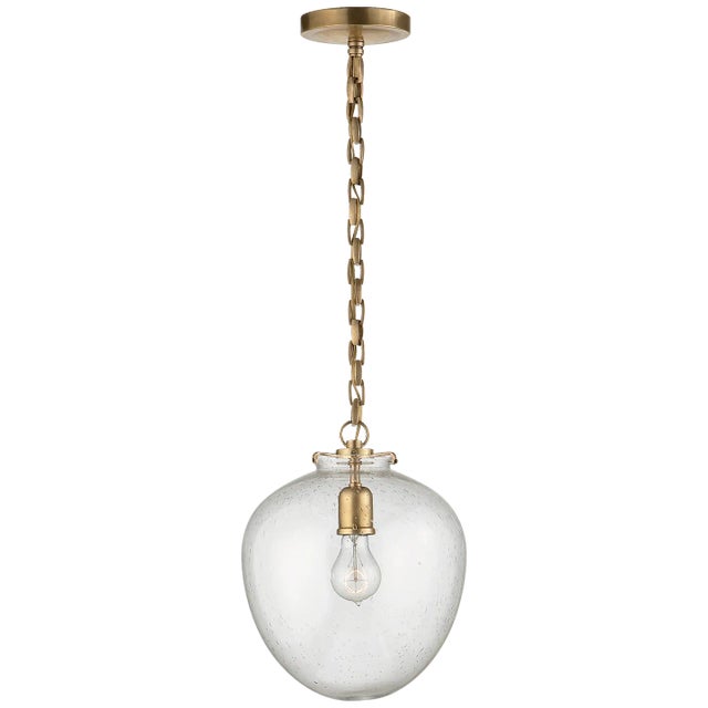 Katie Acorn Pendant in Hand-Rubbed Antique Brass with Seeded Glass Designer: Thomas O'Brien Canopy: 5.25" Round Mounting:...