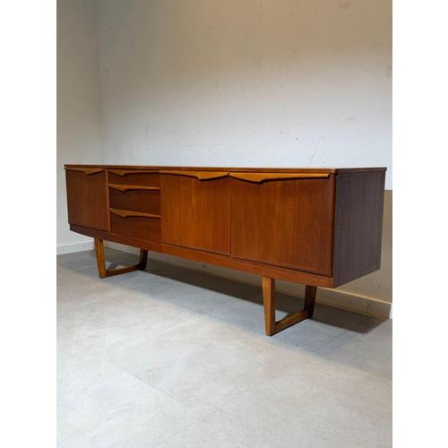 Elegant mid-century modern sideboard by Stonehill , crafted in beautifully grained teak wood and designed with clean lines...