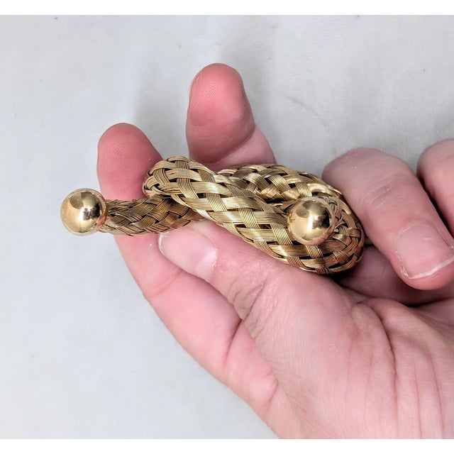 Circa 1955 goldtone woven wires knot with smooth capped ends brooch with security clasp. Marked "NAPIER" on the bar across...