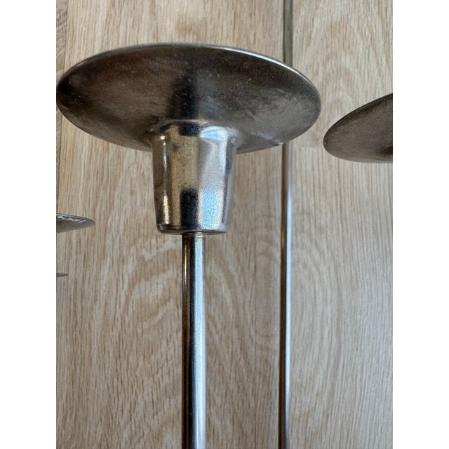 A rare and monumental pair of silvered brass 7-light wall candle sconces, masterfully executed in a sculptural "bundle of...