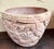 These planters, likely made of terracotta, showcase a decorative style that was popular in the early to mid-20th century,...
