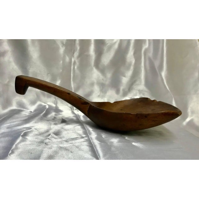 You can still see the grain of the wood in this late 19th century wooden spoon or paddle from France. It has stirred many...