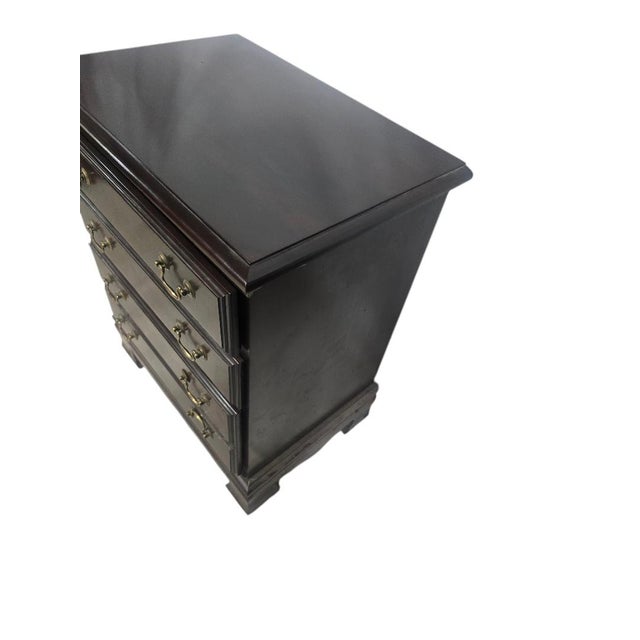 Vintage traditional bachelor chest featuring a deep dark cherry finish, brass bail hardware, and classic bracket feet....