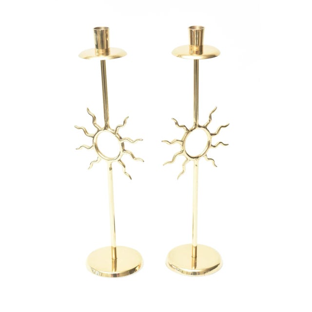 These fabulous vintage pair of polished brass candlesticks are in the style of the Italian master; Piero Fornasetti. His...