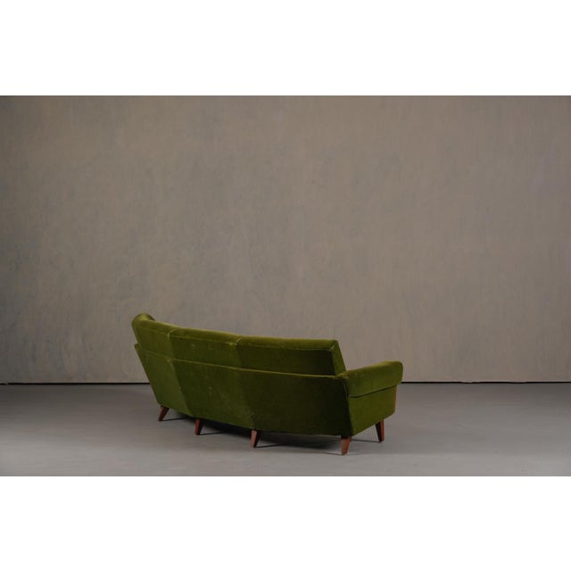 A vintage Danish Boomerang sofa from Denmark, 1960s. The producer and designer are unknown. Made from wood, foam, and...