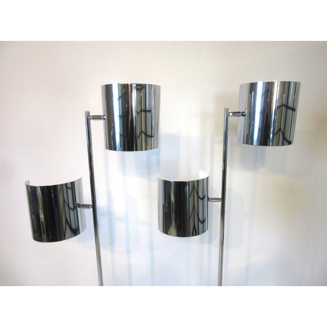 A pair of chrome Sail or Kite floor lamps with adjustable half shades with satin white to the backsides. Well crafted with...