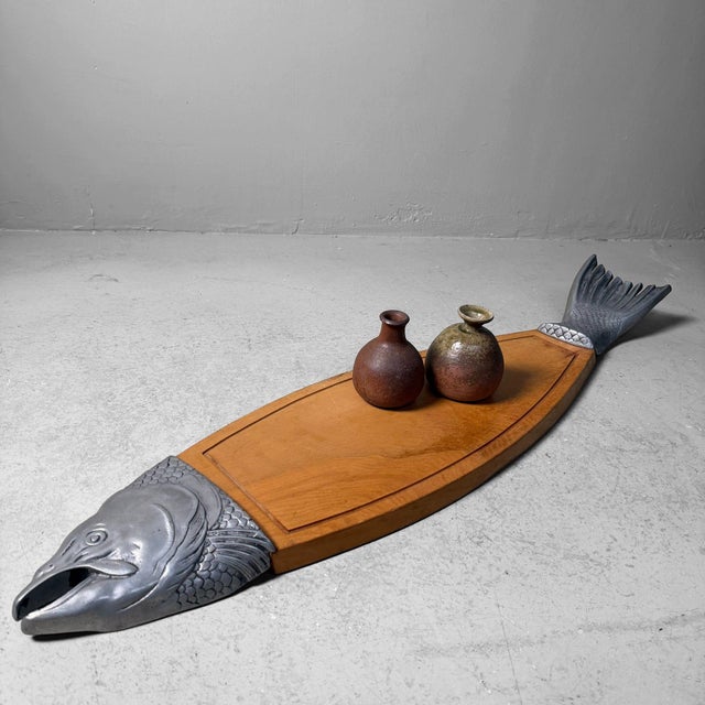 This striking fish-shaped serving board was originally designed to present fish dishes in style—think smoked salmon,...