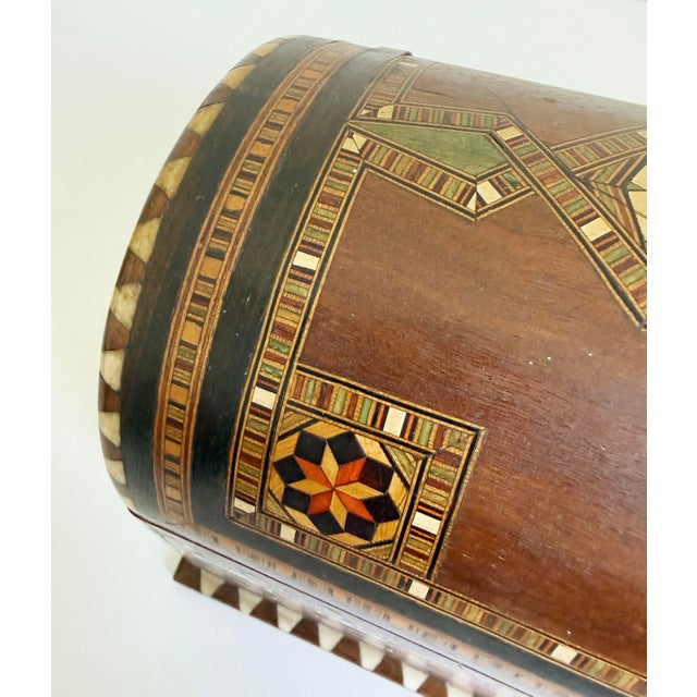 Large inlaid marquetry box with arched lid, made in Spain in the Moorish style, circa 1950s. Features finely detailed wood...