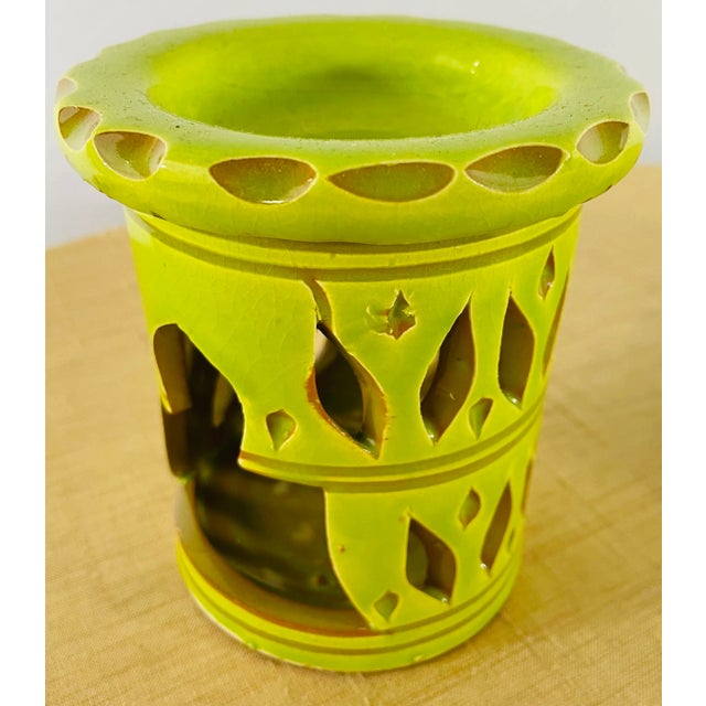 A set of four moroccan candle holders of compatible style. Handcrafted by master ceramic craftsmen in Morocco and hand...