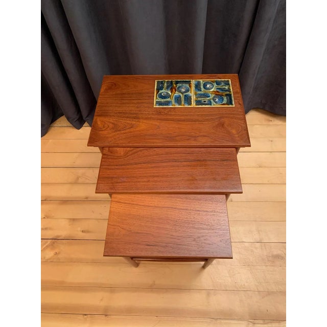 A set of three Danish side tables from the 1960s. The tables are in original and very good condition. The largest table is...