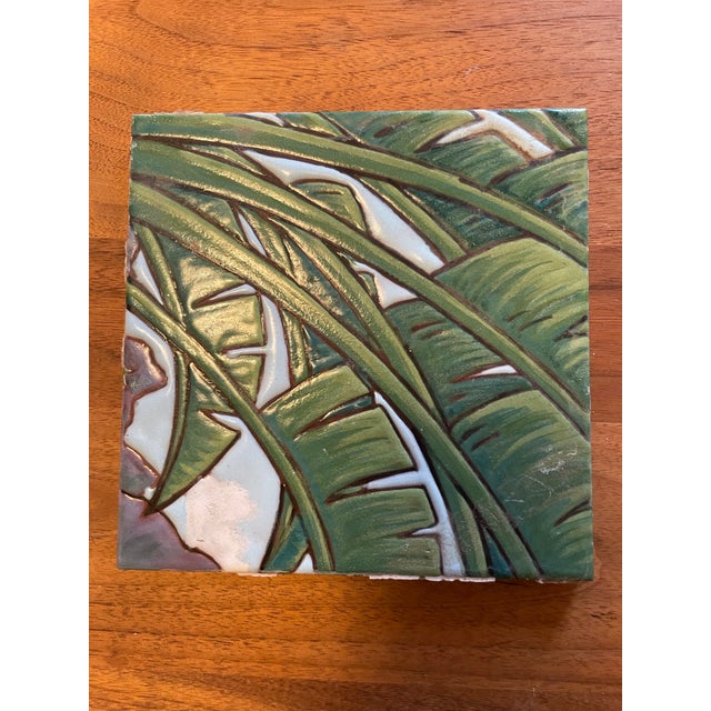 mid-century Italian ceramic tiles feature richly glazed, hand-crafted relief designs. sweeping palm fronds, dense...