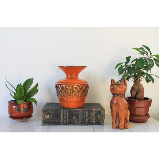 Vintage Haeger Pottery geometric vase. Orange with a relief, repeating geometric pattern. design. Makers mark on bottom....