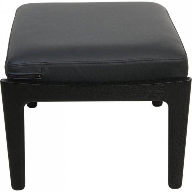 Hans Wegner GE-290 stool with a frame of black lacquered oak and a new cushion upholstered with black bizon leather. The...