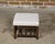 An English bobbin stool from the 19th century with linen upholstered seat and brass nailhead trim. Bringing timeless charm...