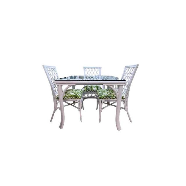 Add timeless Palm Beach flair to your space with this vintage rattan dining set, featuring a glass-top table and four...