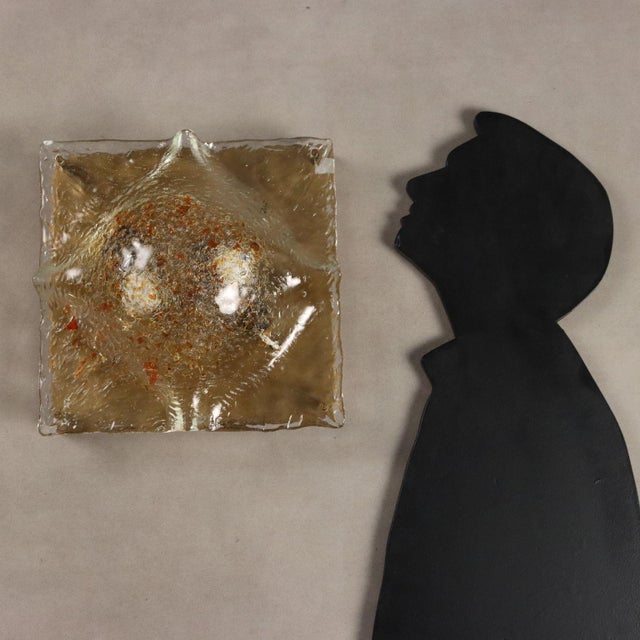 Vintage ceiling lamp with metal frame and transparent curved and worked glass diffuser with orange decorations. This piece...