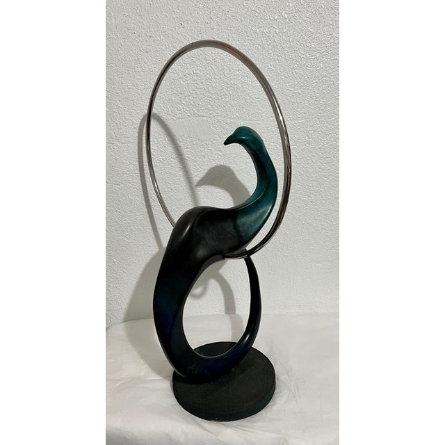 Colin Webster Watson (1926-2007). A patinated cast bronze sculpture of a stylized bird with a steel ring. Signed, numbered...