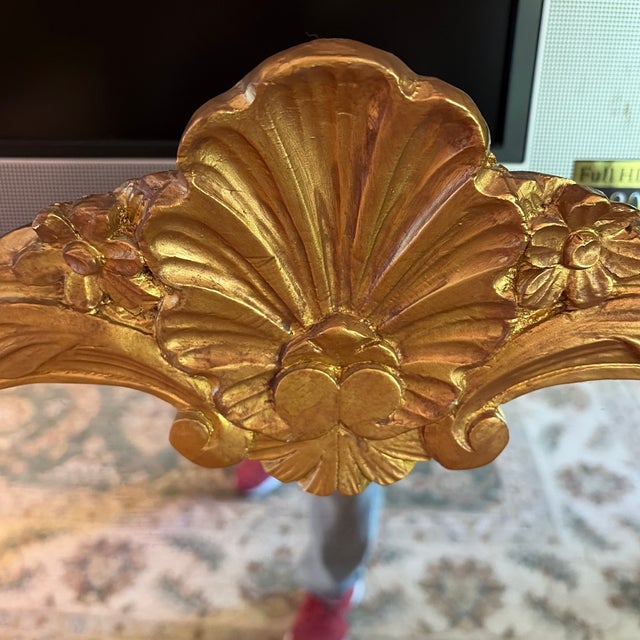 Beautiful, traditional style wall mirror with gold frame in shell motif design. The frame is constructed of molded resin....