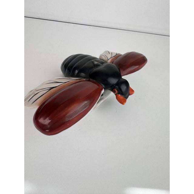 A nice accent piece for your wall. This bee has a glazed black body and wings that are deep brown & white lustre in color....