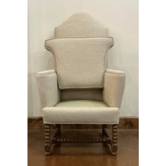 This small scale, antique wingback chair has bobbin turned front legs and risers with splayed back legs. Beautiful and...