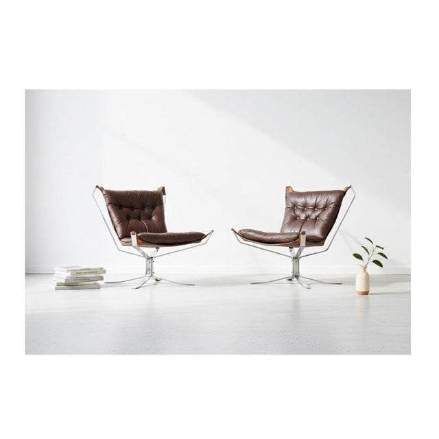 Elegant Danish pair of 1970s 'Superstar' armchairs featuring leather upholstery and a sleek steel frame. A stylish and...