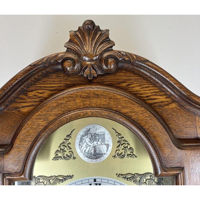 A beautifully crafted Vintage Oak Grandfather Clock , featuring an elegant longcase design with ornate carvings and...