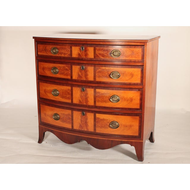 American federal mahogany and feathered birch bow front chest of drawers, circa 1800. With a single board bow shaped top...
