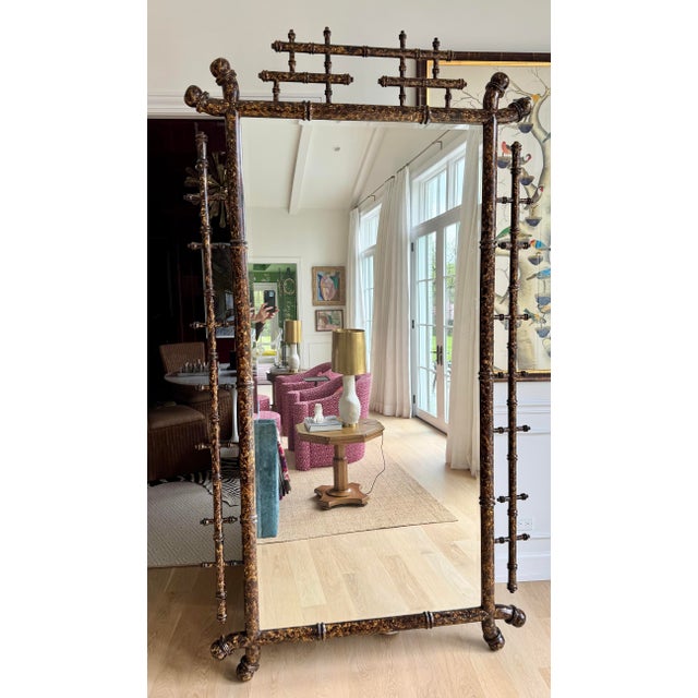 A monumental, overscale faux tortoiseshell bamboo wall mirror by William Switzer, designed in the English Regency taste...