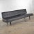 Handsome mid-century modern settee or loveseat sofa in black vinyl faux leather by Universal of High Point. It is in...
