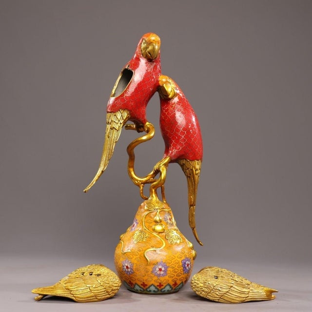 This striking incense burner is modeled as a pair of parrots perched on a gnarled branch atop a double-gourd base. The...