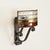 Stunning and unique large brutalist-style wall sconce, crafted from wrought iron and sculpted colored glass. This...