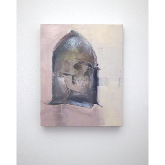 The artwork depicts a skull encased within a stylized, reflective surface reminiscent of a historical helmet, evoking a...