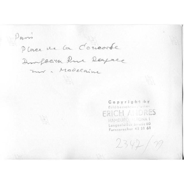 This photograph, taken in 1952, depicts the Place de la Concorde in Paris, France. The scene captures a busy urban...