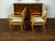 A pair of English Regency walnut armchairs from the mid 19th century, with large scrolling arms and green upholstery....
