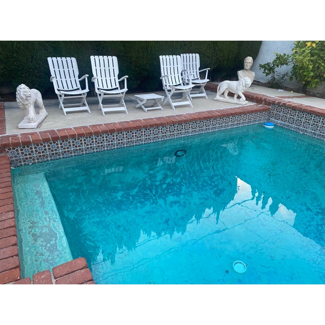 Pairs of lions Limestones statues . Carved limestones statues in the neo classical style explosive ribs and musculature.