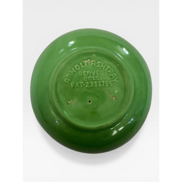 A patented mid-century American ceramic catch-all in vivid chartreuse glaze, designed by Harry M. Anholt of Denver,...