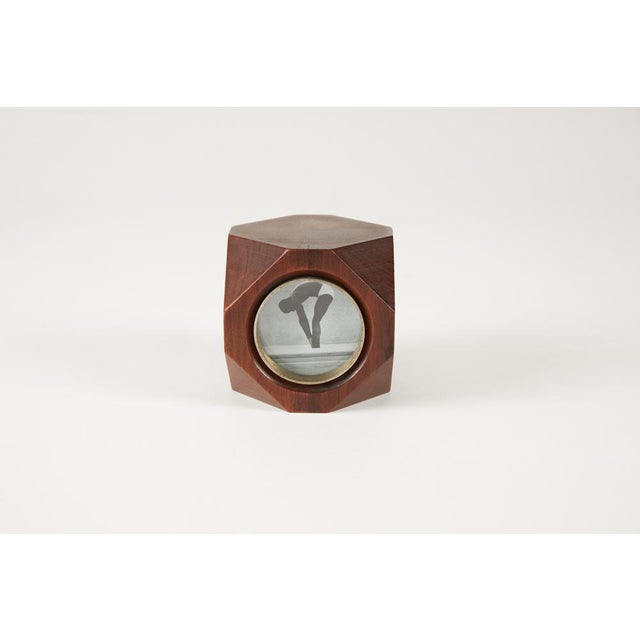 Four-sided photo frame in walnut wood with matte chrome-plated brass joints, featuring protective glass and signed on the...