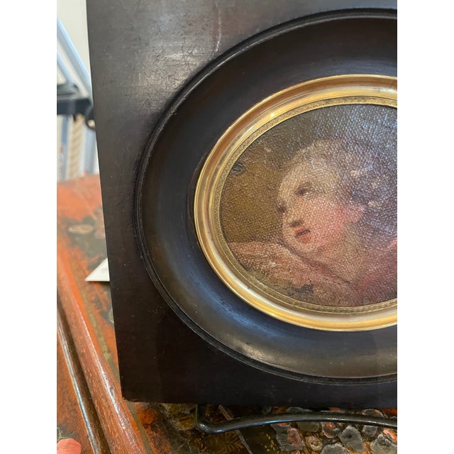 This type of small, oval-shaped 19th century oil on canvas painting is commonly known as a portrait miniature, often...