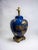 This lovely table lamp is a perfect blend of history and art, featuring a bright blue lacquer finish that is reminiscent...