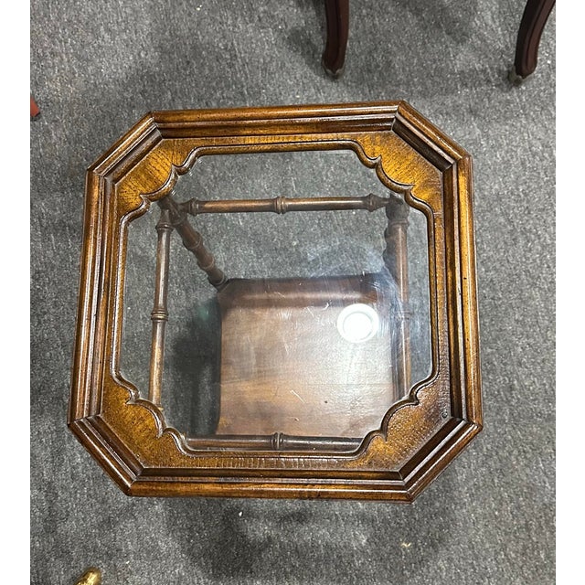 Small faux bamboo octagon glass top side table . Circa 1960’s Measures 14” x 14”x 21” Faux bamboo legs and stretchers....