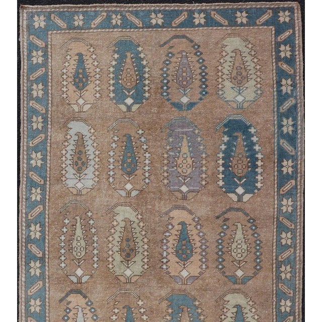Measures: 3'5 x 6'1. This charming vintage Turkish Tulu rug showcases a unique pattern of paisley medallions, each filled...