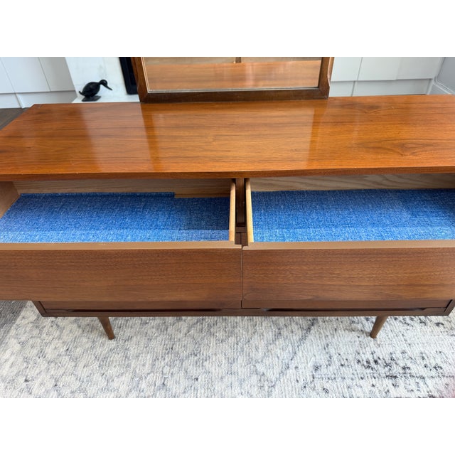 Absolutely stunning mid century modern walnut lowboy dresser featuring sleek, clean lines, sculpted drawer pulls, and...