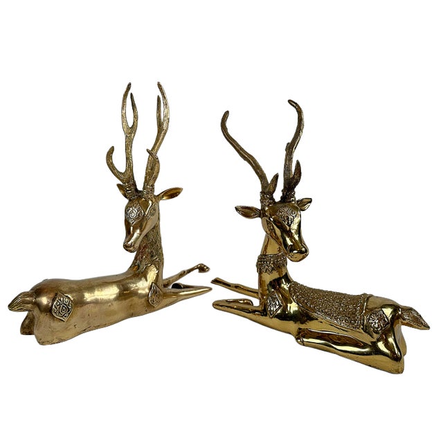 This is a pair of 1970's brass resting reindeer. These two have their neck turned and are adornment around his neck, back...