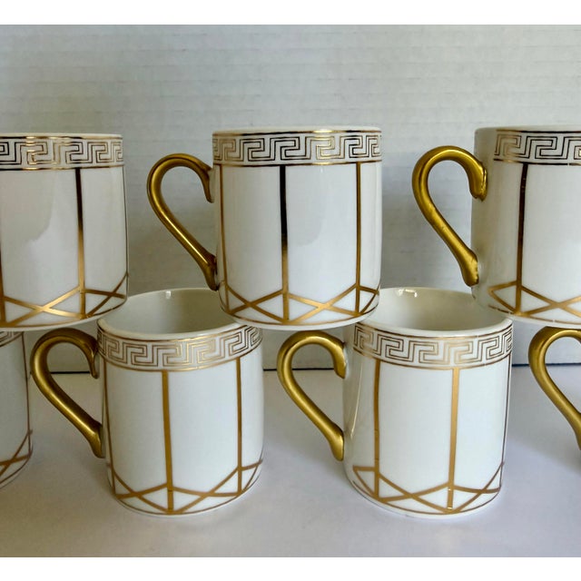 Here is a beautiful vintage set of seven porcelain espresso/demitasse cups featuring crisp geometric gold decoration...